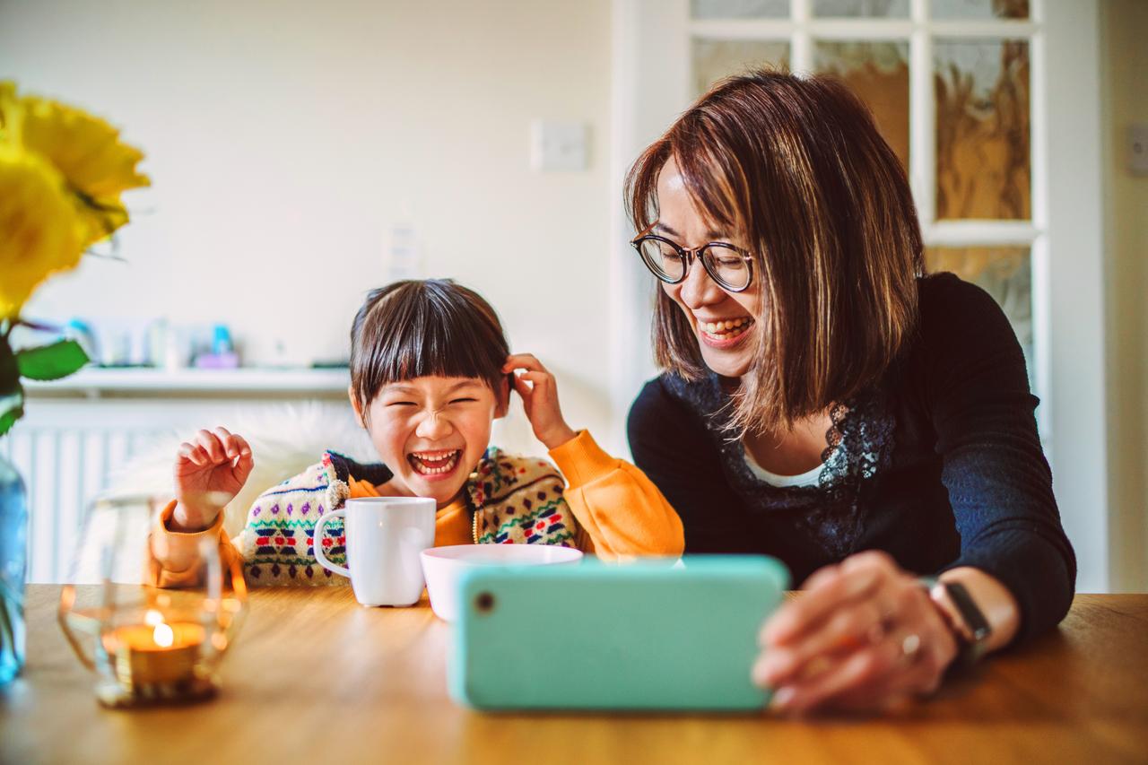 Mom_&amp;_daughter_having_video_call_on_smartphone_at_home_.jpg