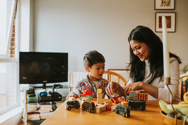 Mother_and_Son_play_with_wooden_building_blocks_at_home.jpg