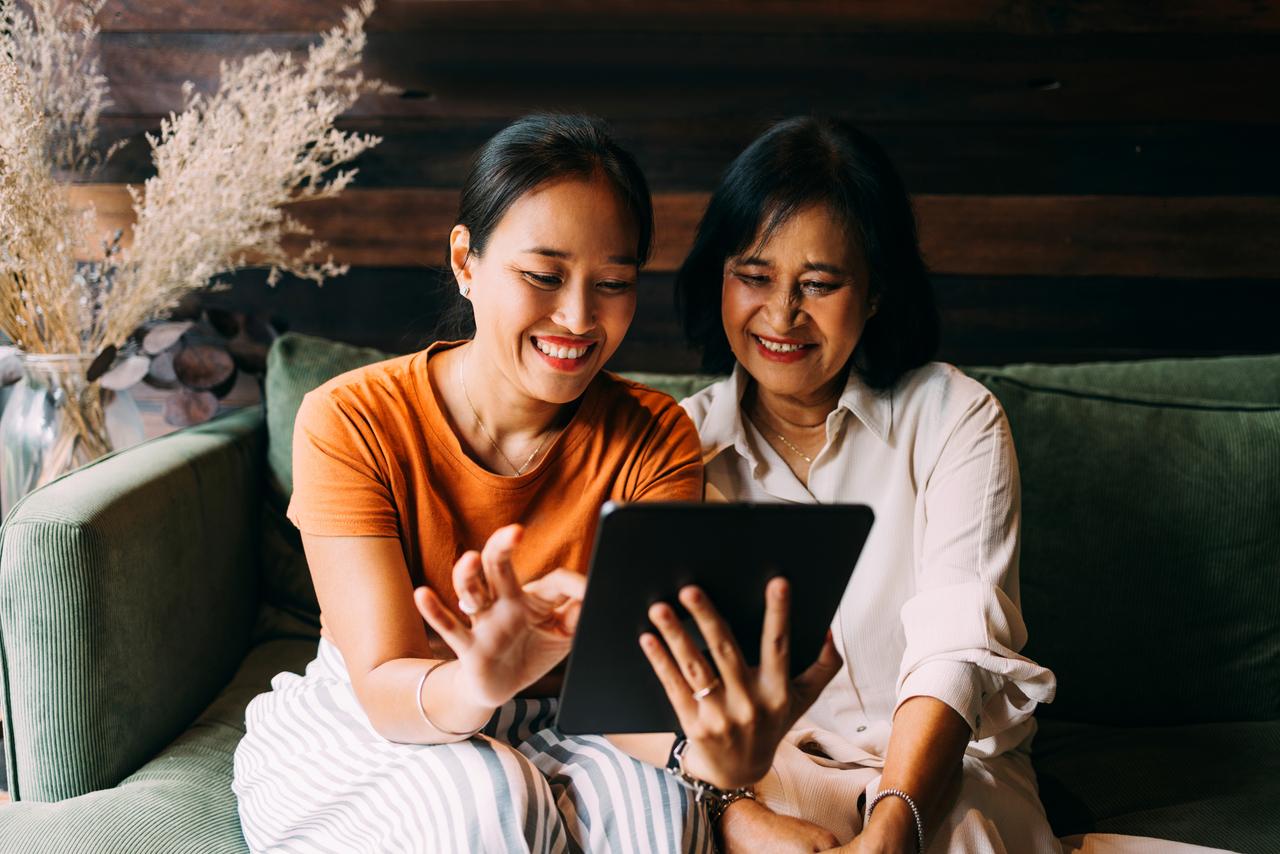 Mother_And_Daughter_Looking_At_The_Photos_On_The_Tablet.jpg